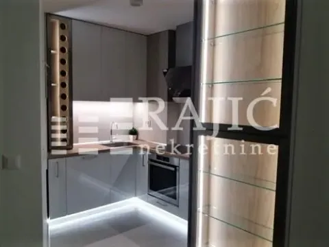 Modern kitchen with built-in appliances and lighting. - image 4