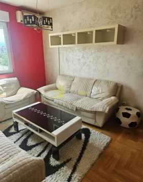 Living room with seating furniture, coffee table, and a window. - image 4