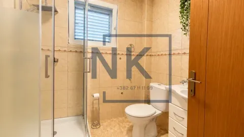 Bathroom with a shower cabin, toilet, and vanity with a sink. - image 19