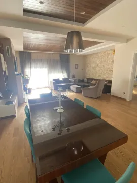 Spacious living room with a dining table and decorative ceiling. - image 3