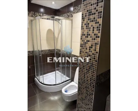 Bathroom with a shower cabin and toilet, tiled with ceramic tiles. - image 15