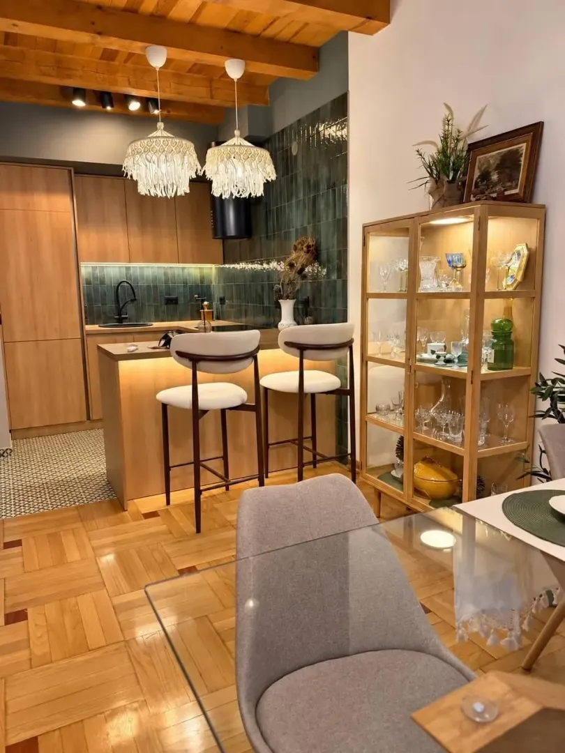 Modern kitchen with a breakfast bar and dining area.
