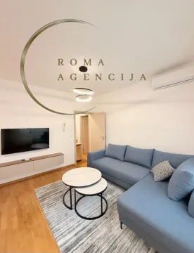 Modern and bright living room with a sofa and television. - image 3