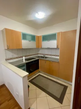 Smaller kitchen with wooden elements and built-in appliances. - image 4
