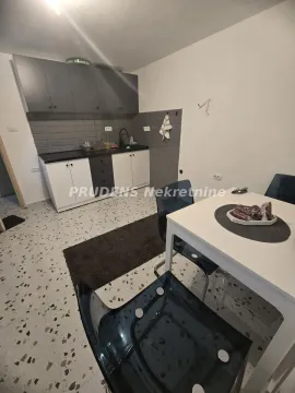 Small kitchen with a dining table and chairs. - image 4