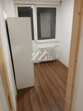 Small empty room with laminate flooring, white radiator, and balcony access. - image 6