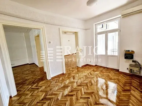 Empty room with hardwood floors and doorways leading to other areas. - image 11