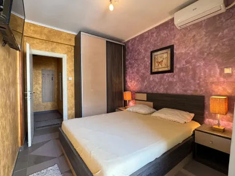 Bedroom with a double bed, wardrobe, and bedside lamps. - image 7