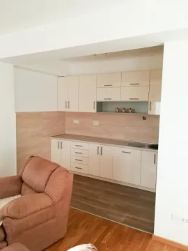 Compact kitchen with light-colored cabinetry as an extension of the living room. - image 2