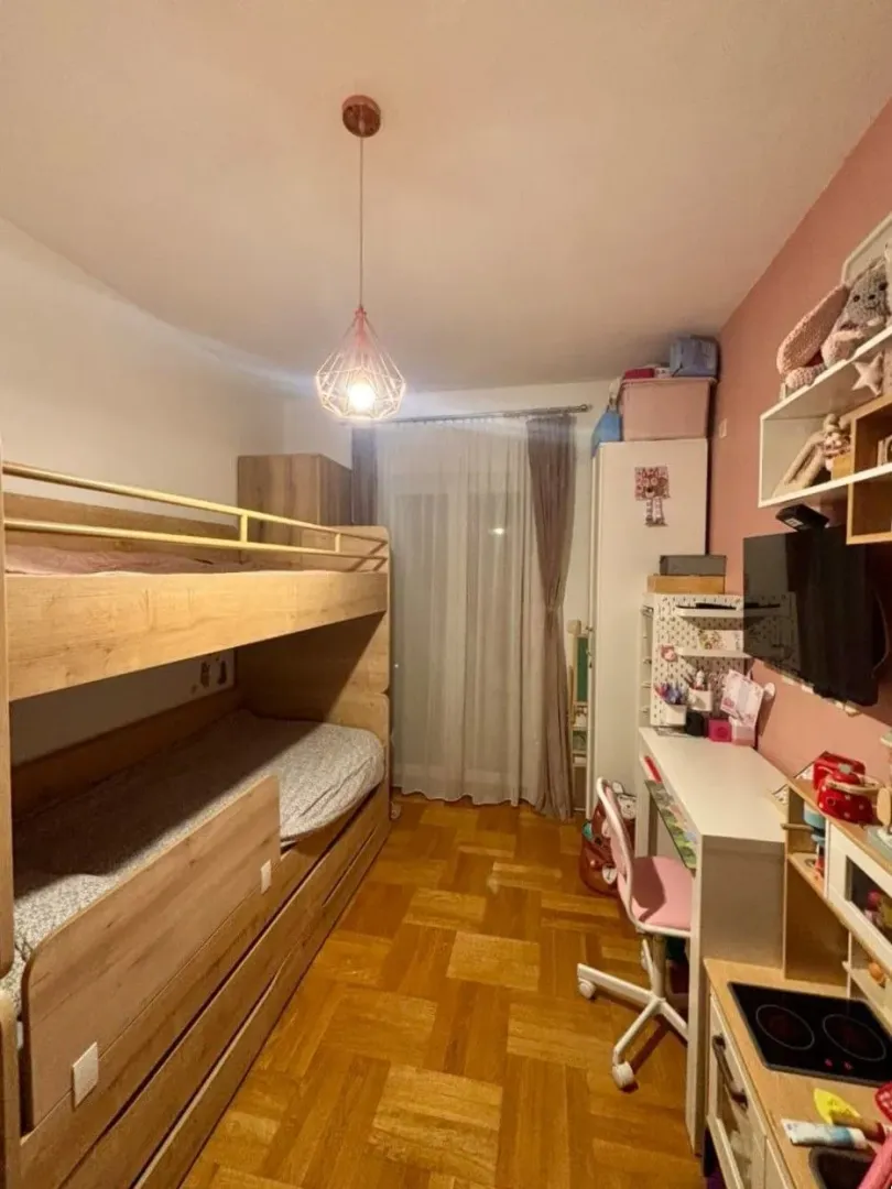 Children's bedroom with a bunk bed and a desk.