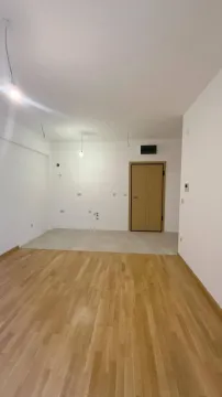 Empty room with hardwood and ceramic flooring under construction. - image 7