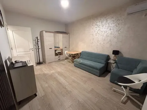 Living room furnished with a sofa set, wardrobe, and a desk. - image 4
