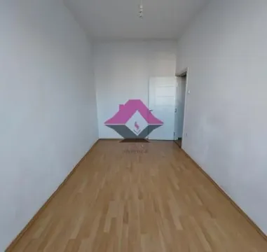 Empty room with laminate flooring and white walls. - image 11