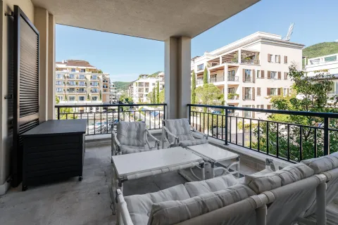 Natkriveni balkon sa garniturom za sjedenje i pogledom na okolne zgrade. - image 2
