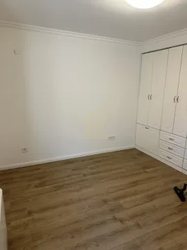 Bedroom with a white wardrobe and laminate flooring. - image 12