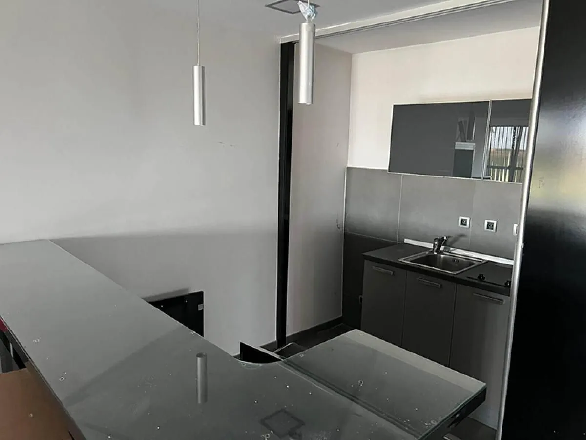 Smaller kitchen with dark cabinets and a breakfast bar.