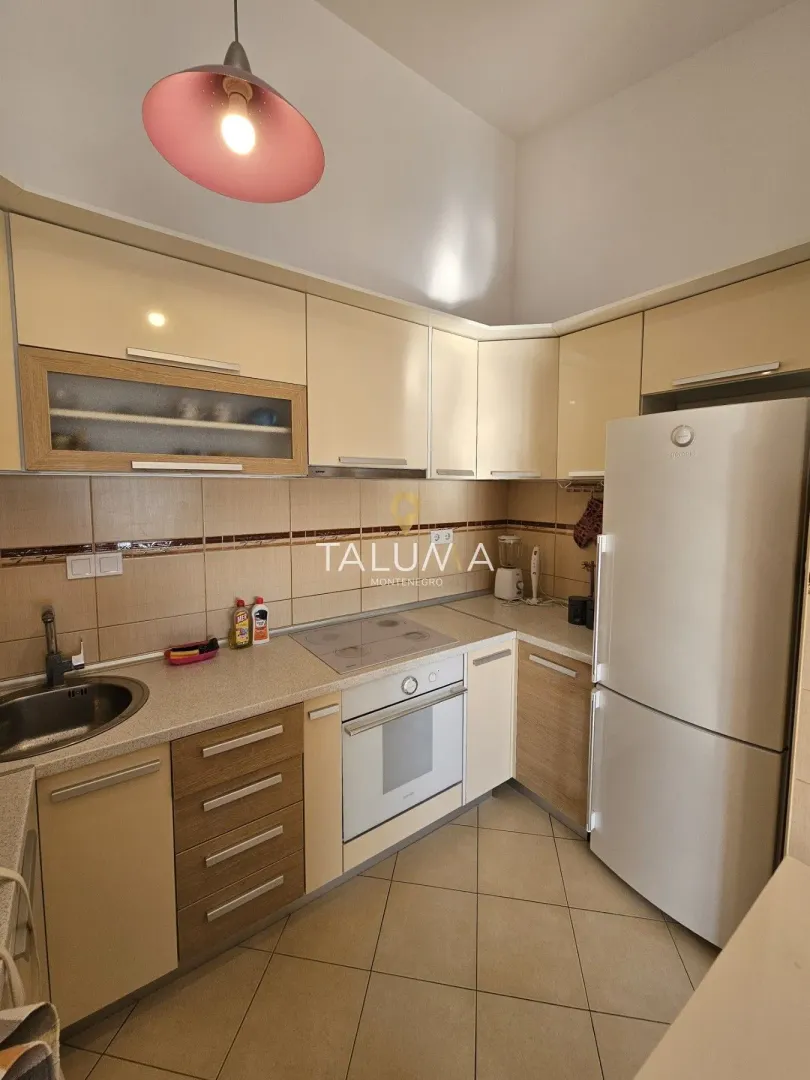 Compact kitchen with fitted units and home appliances.