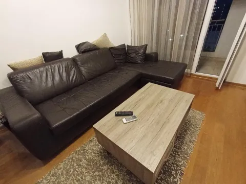 Dnevna soba sa ugaonom garniturom i drvenim stočićem. - image 6