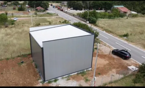 Aerial view of a modern prefabricated building and surrounding property next to the road. - image 4