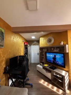 Living room with a desk and a television. - image 3