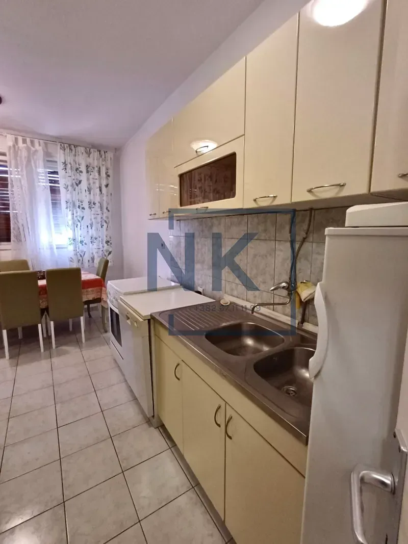 Kitchen equipped with light-front cabinets and a sink.