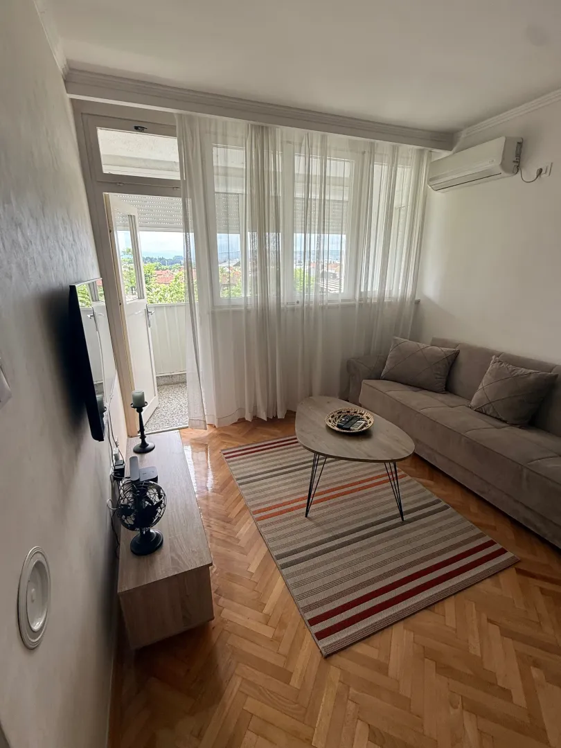 Living room with sofa, coffee table and access to the terrace.