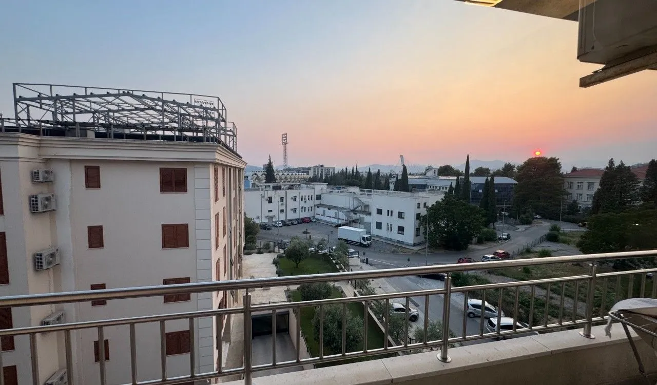 View of the city and landscape from the balcony at dusk.