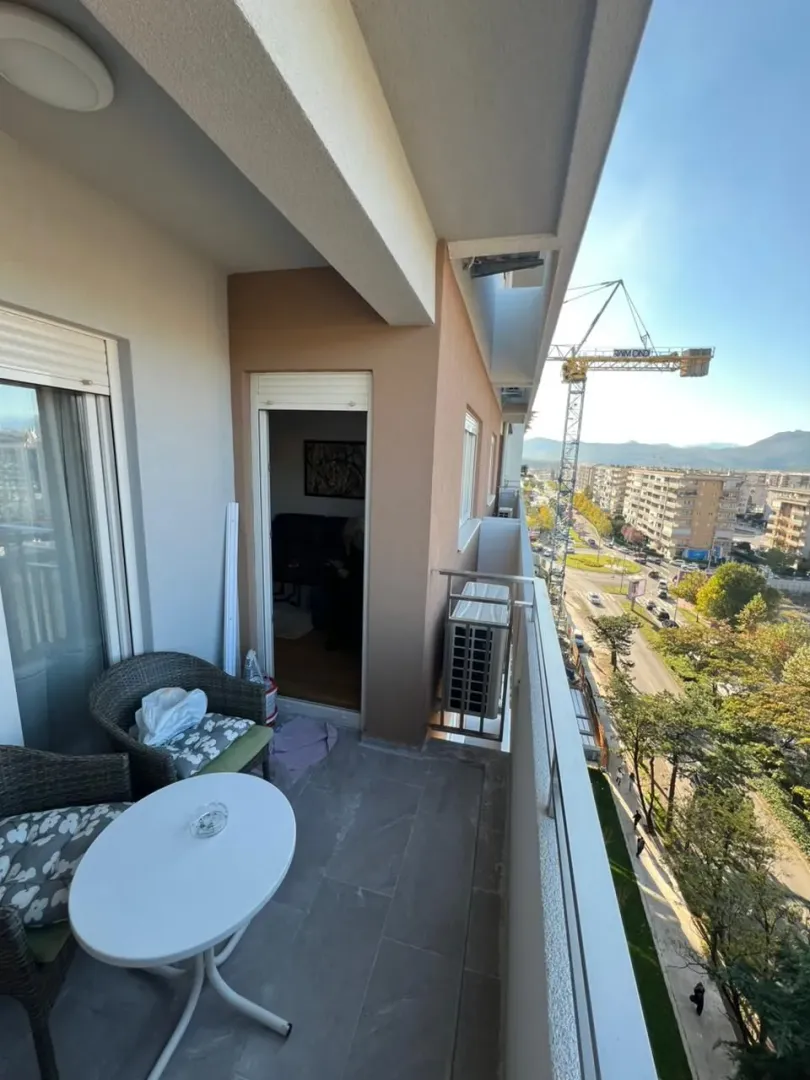 Furnished balcony with outdoor seating and a view of the city street.