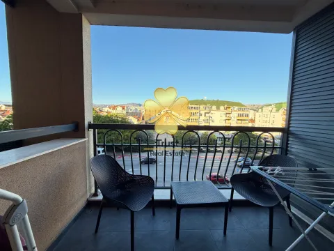 Furnished balcony with seating set and city view. - image 7
