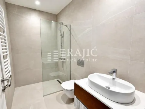 Modern bathroom with a walk-in shower and a washbasin. - image 8