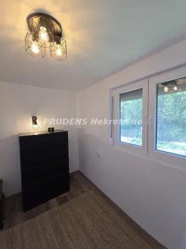 Small room with a chest of drawers and a window overlooking nature. - image 16