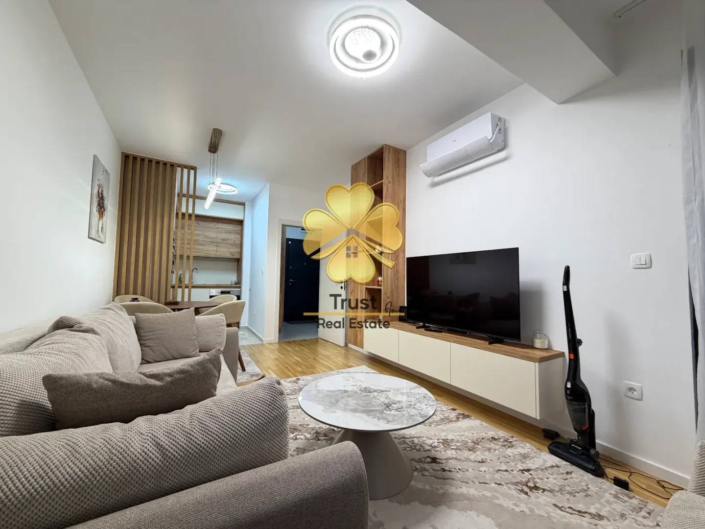 Modern and bright living room with a sofa and television.