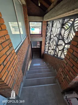 Interior staircase with brick walls and decorative railing. - image 14