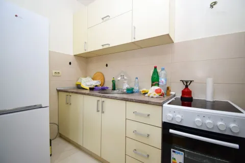 Smaller kitchen with a refrigerator, sink, and stove. - image 6