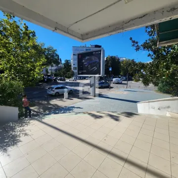 View from the terrace onto the city street and surrounding buildings. - image 4
