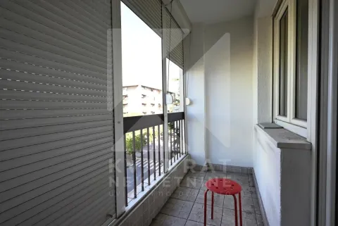 A view of the balcony with floor tiles and window shutters. - image 23