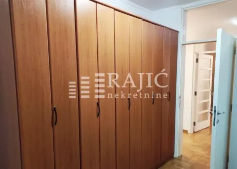 Bedroom with a large wooden wardrobe. - image 6