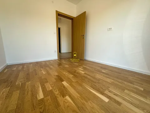Prazna soba sa parketom i otvorenim drvenim vratima. - image 9