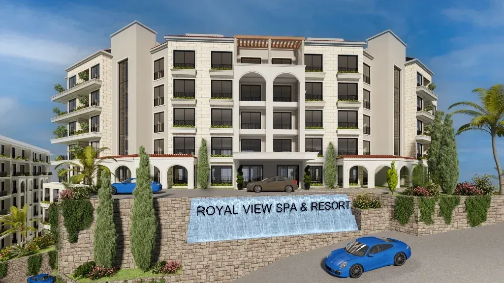 Front view of a multi-story complex building with landscaped yard and parking.