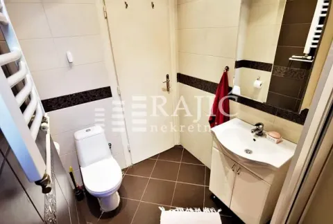 Small bathroom with a sink, toilet, and mirror. - image 10