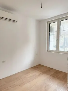 Empty room with white walls, wooden flooring, air conditioner and a window. - image 4