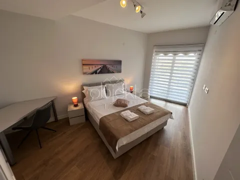 Bedroom with a double bed, nightstands, and a desk. - image 11