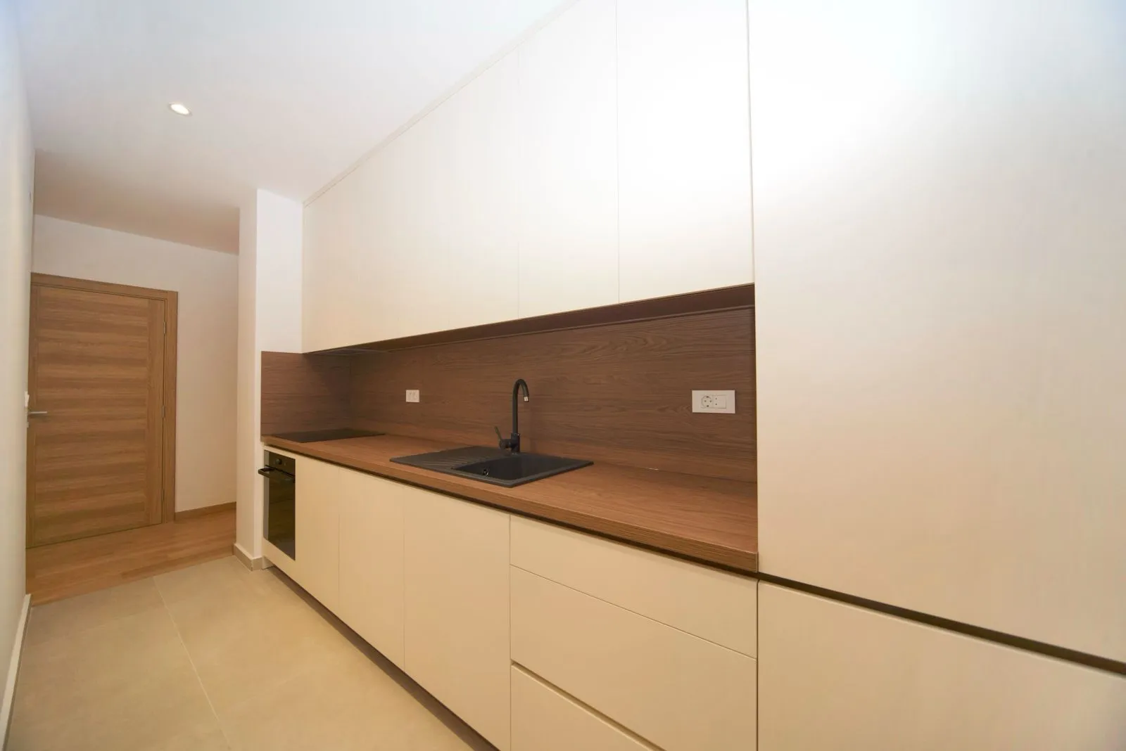 Modern kitchen with built-in cabinetry and a sink.