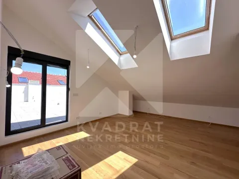 Empty attic room with hardwood flooring, skylights, and access to the terrace. - image 20