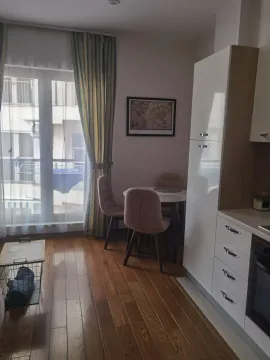 Modern kitchen with a dining table and chairs. - image 3