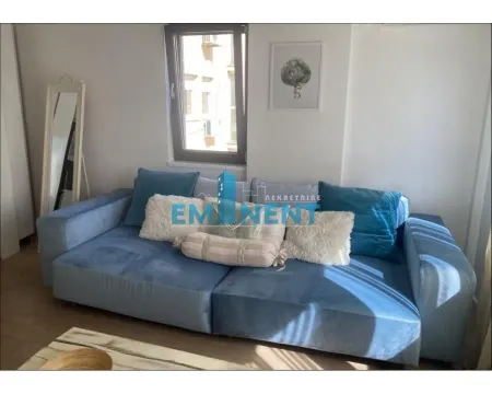 Living room with a comfortable blue sofa and a window. - image 3