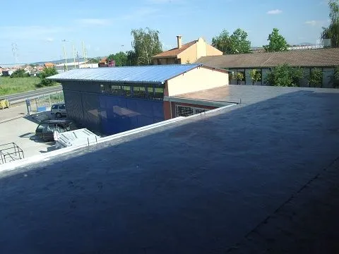Exterior view of the roof and surrounding buildings. - image 7