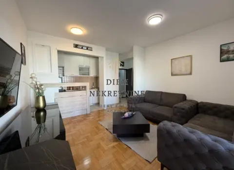 Living room with a sofa set and a view towards the kitchen. - image 2