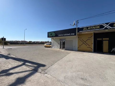 Exterior of a commercial building with parking and a sign. - image 2