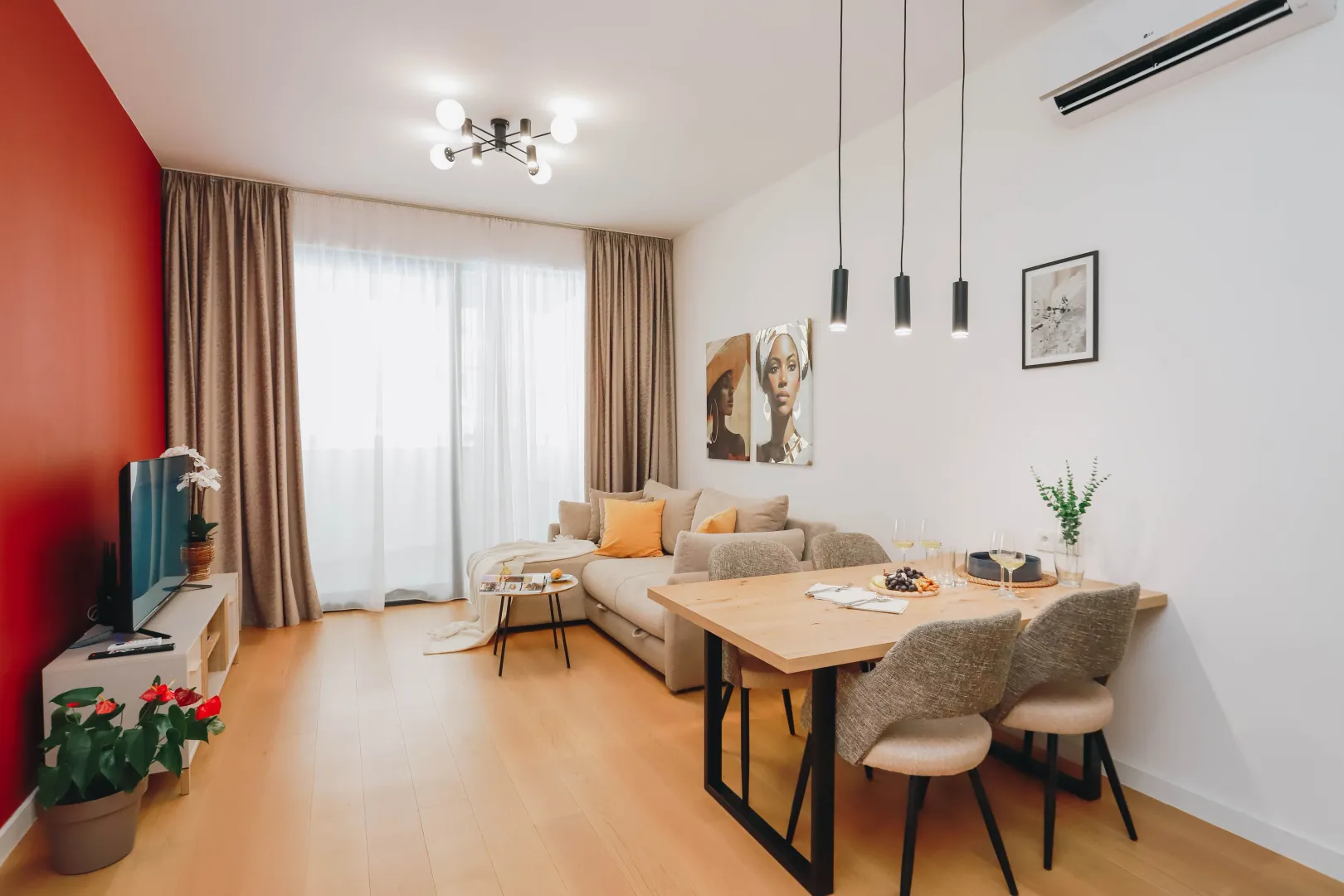 Living room with dining area, sofa and TV unit.
